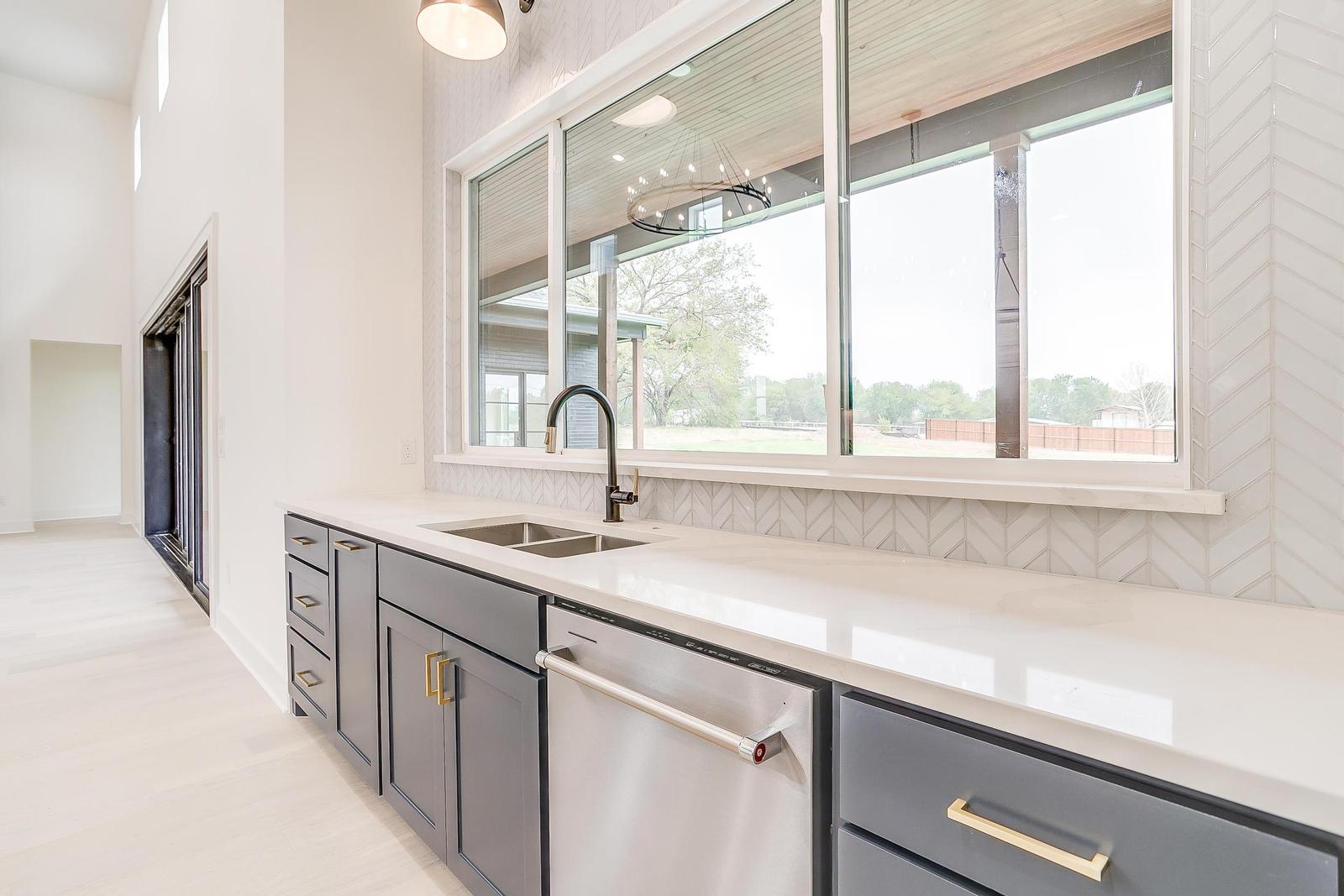 Gourmet kitchen with large island in luxury custom home Burleson Texas